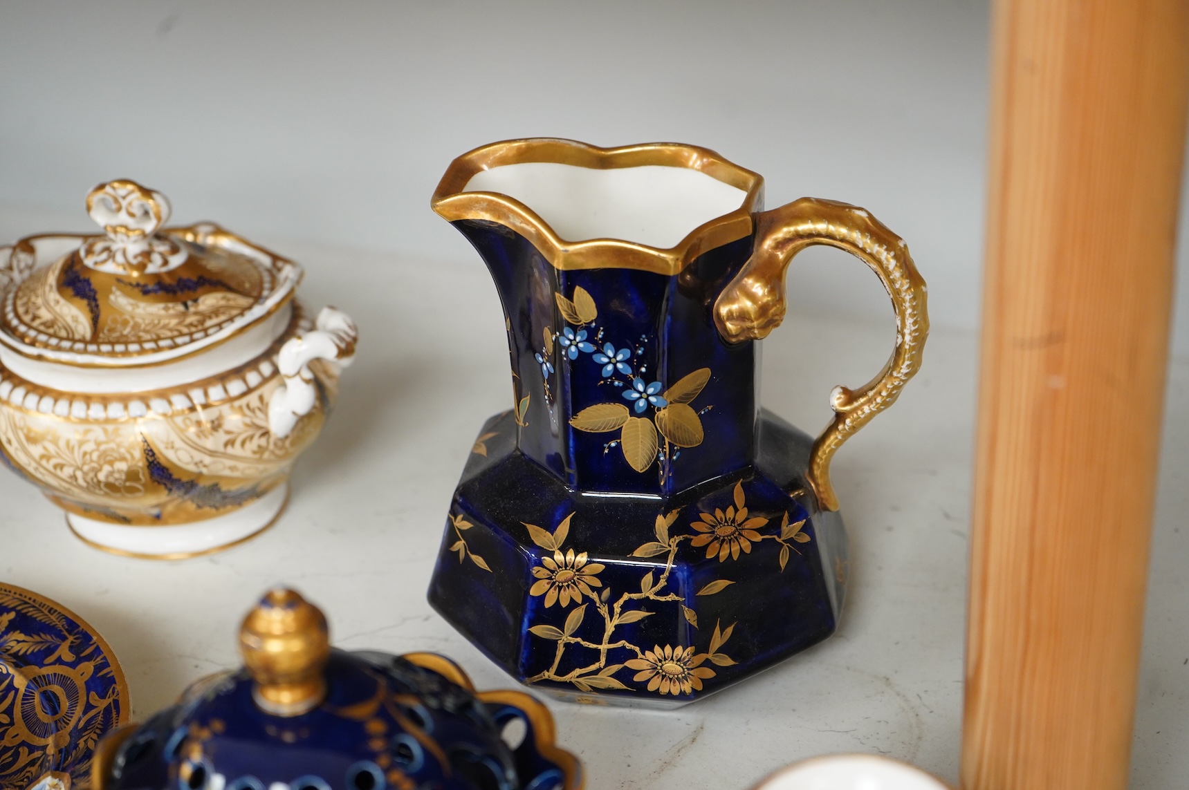 A Group of early 19th century English porcelain; to sauce tureens and covers, one with stand, a covered sugar bowl, a two handled vase, a pot pourri vase and cover, a milk jug and a hydra shaped jug, largest 16cm high